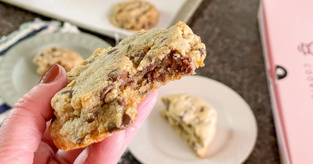 holding a keto copycat crumbl cookie with a bite out of it