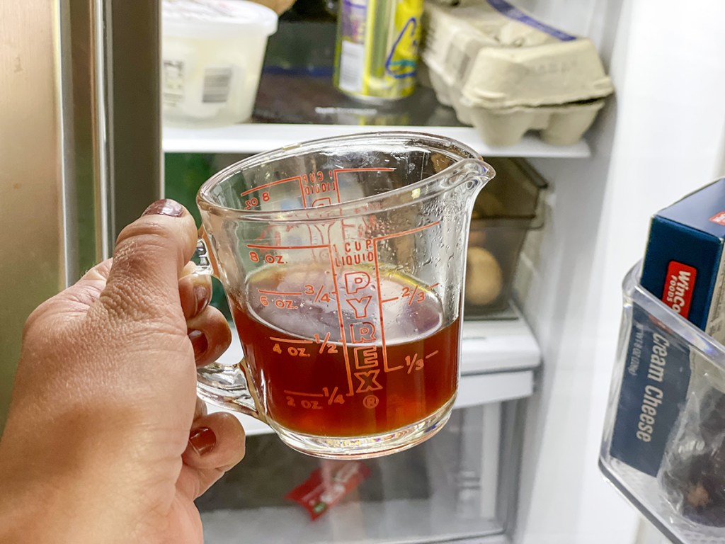 putting chai tea concentrate into the fridge 