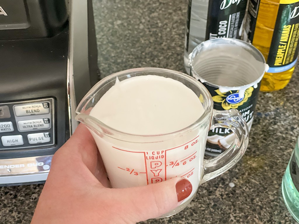 coconut milk in a measuring cup
