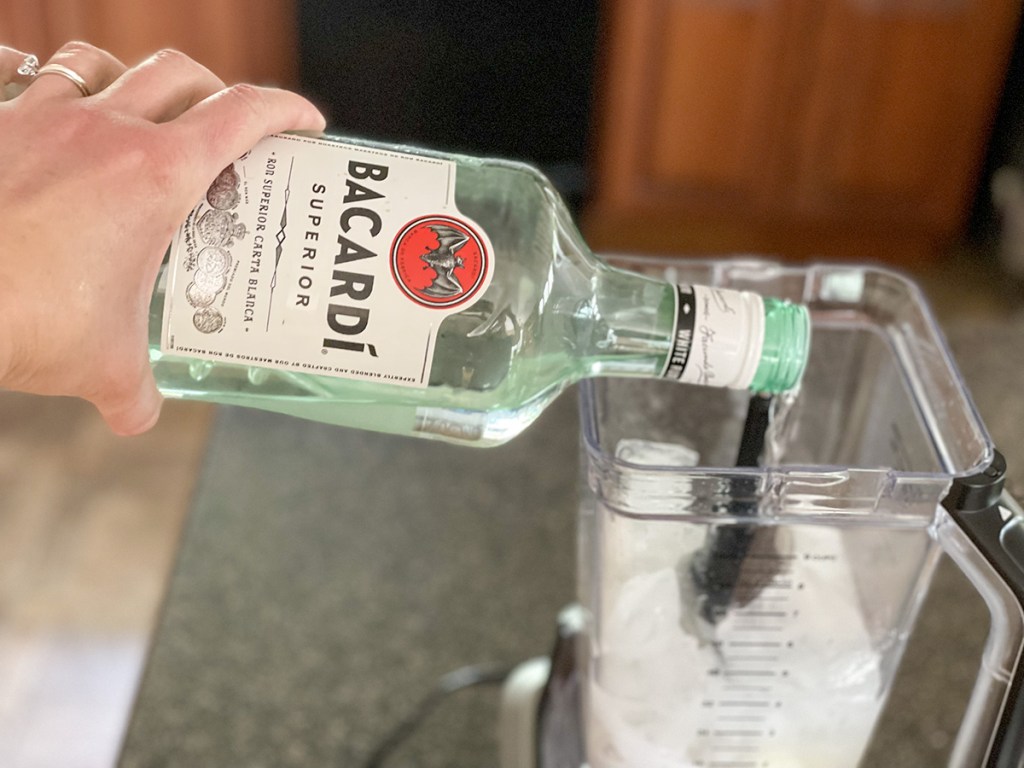 adding rum to a blender