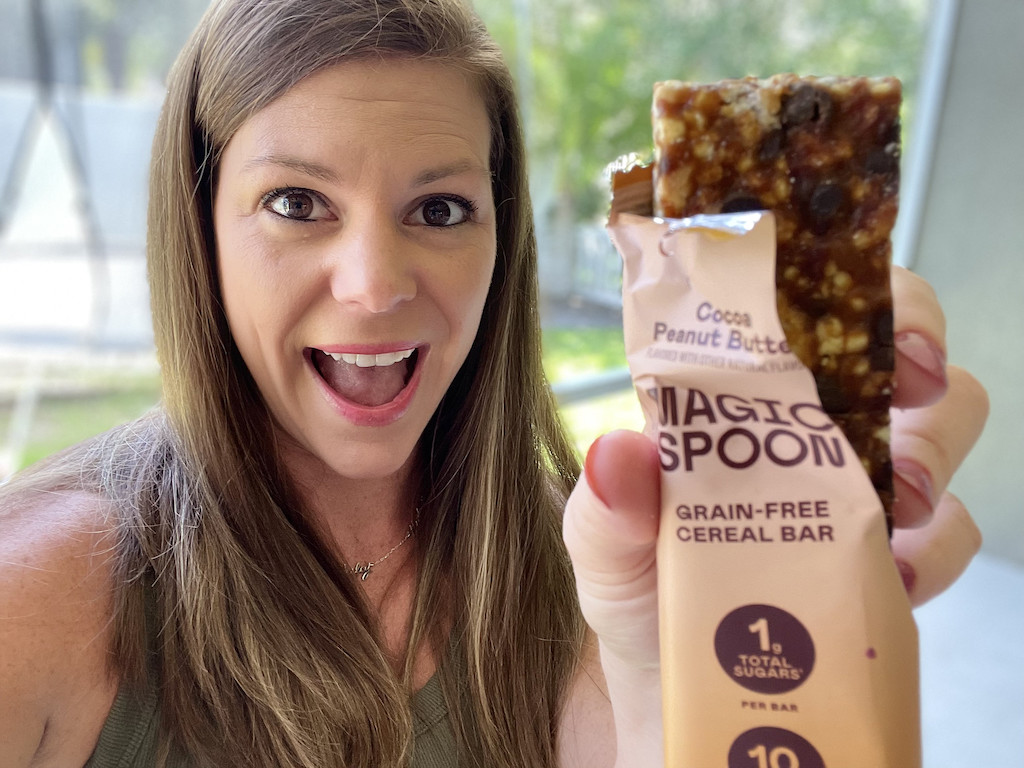woman holding Magic Spoon cereal bar 