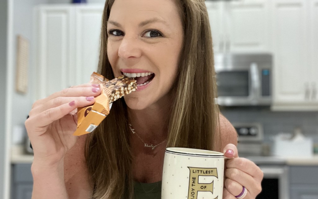 woman eating keto cereal bar