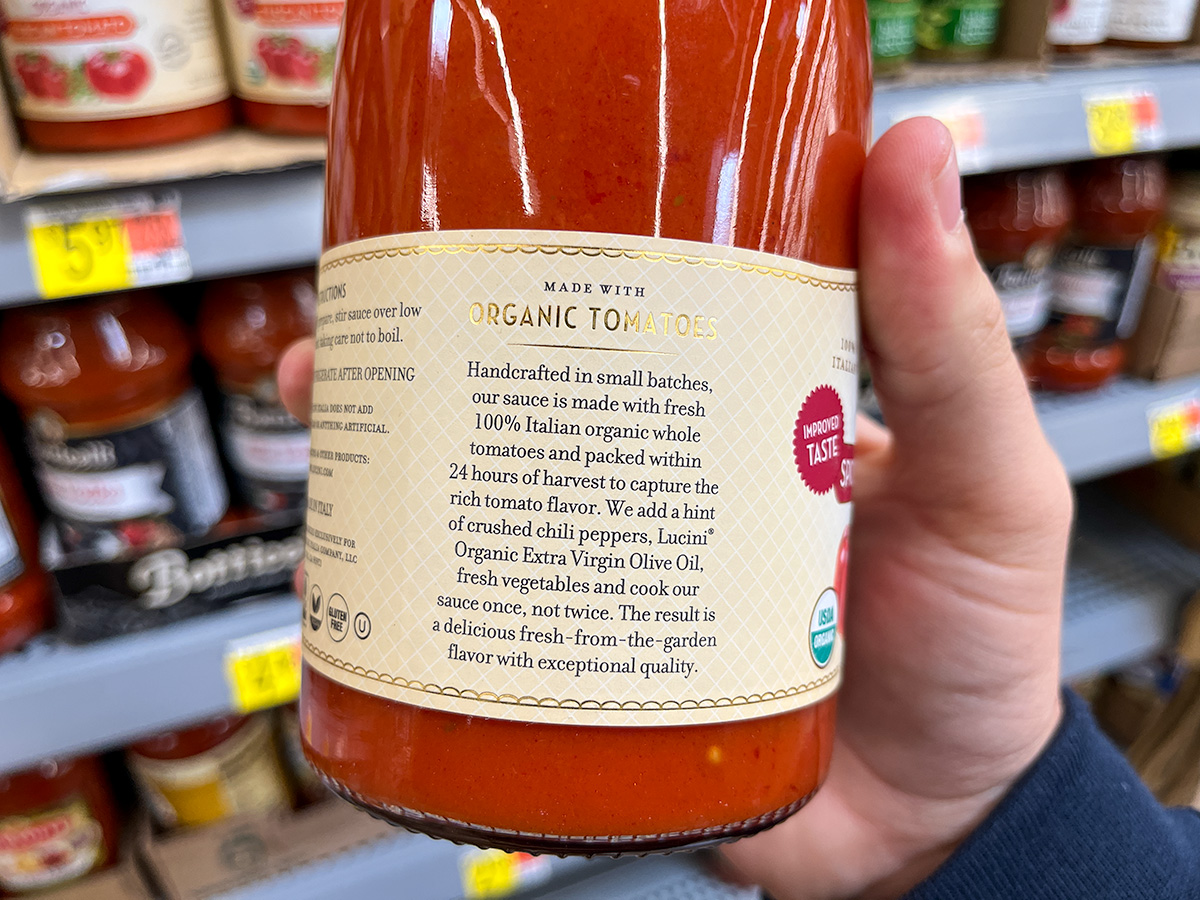 holding jar of lucini pasta sauce show back of the label
