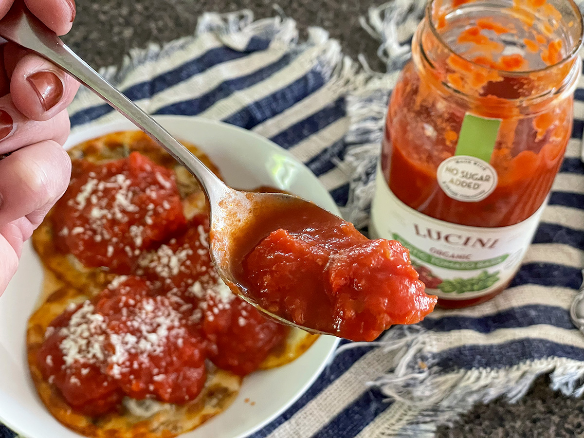 spoonful of lucini pasta sauce and using it on keto ravioli