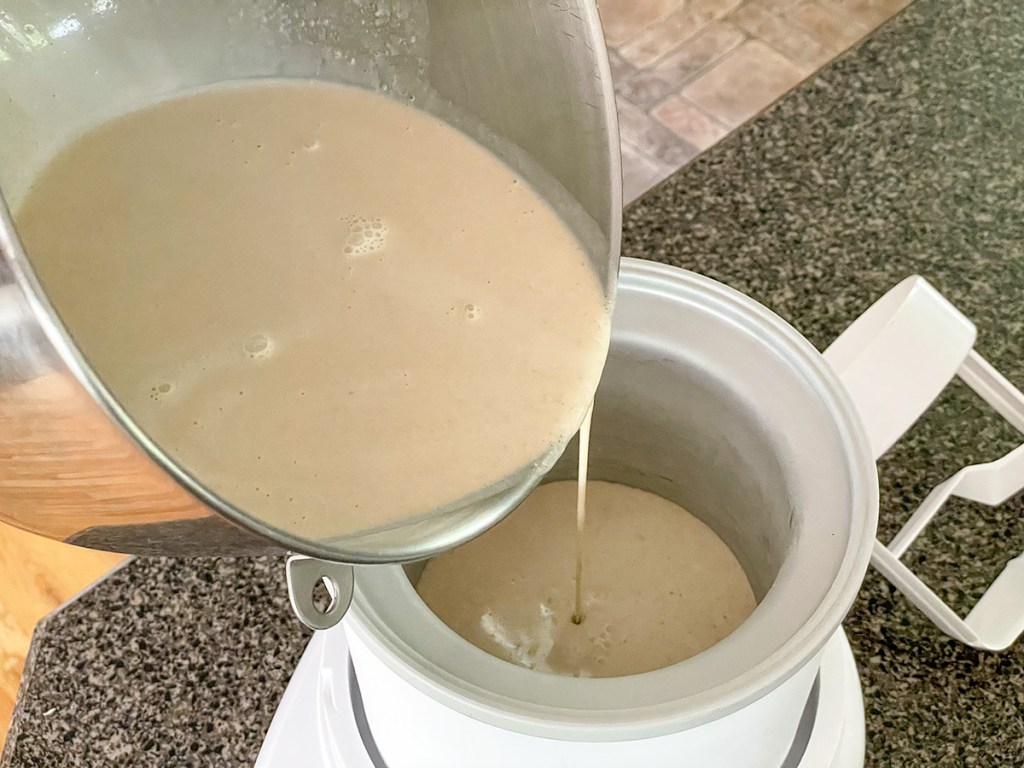 pouring ice cream base into ice cream machine 