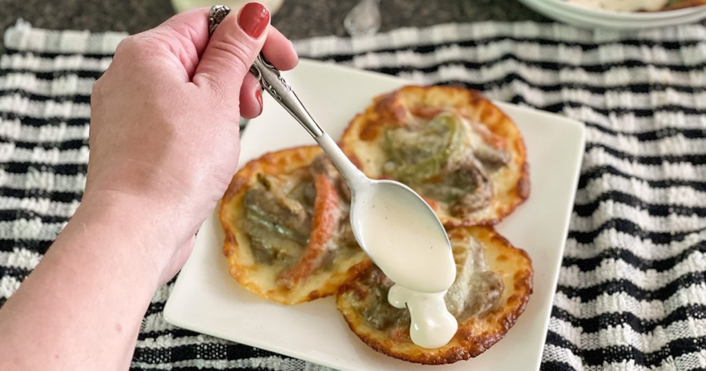 adding Alfredo sauce to Philly cheesesteak keto ravioli