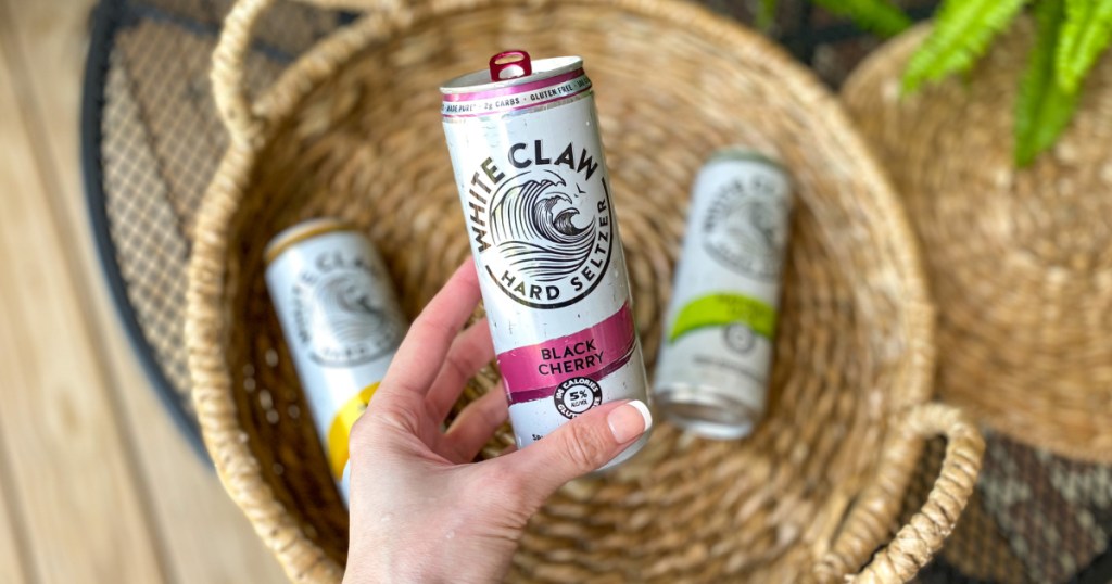 Hand holding a white claw hard seltzer which is a great keto seltzer option