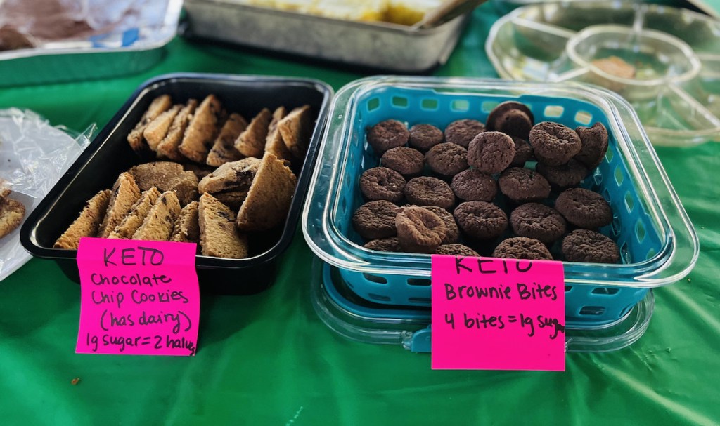 trays of keto chocolate chip cookies and brownie bites on party food table