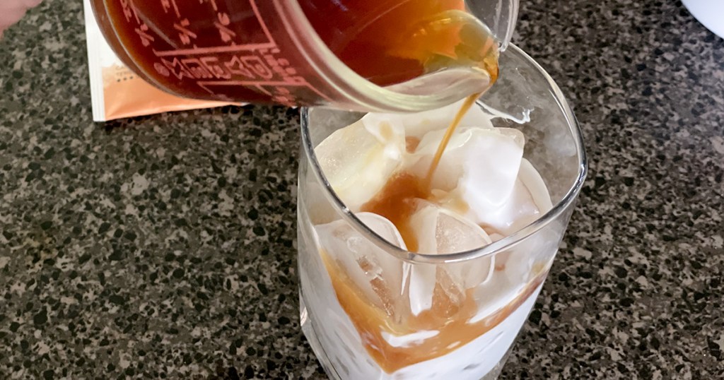 iced chai tea latte pouring in concentrate