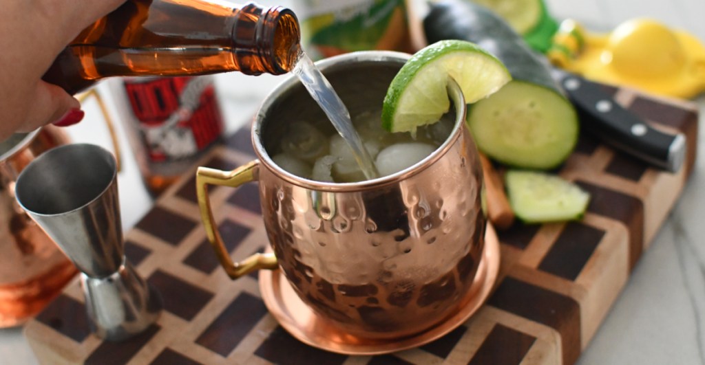 Pouring diet ginger beer into a keto moscow mule
