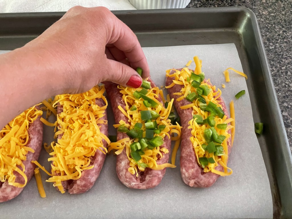 adding jalapeños to stuffed sausage