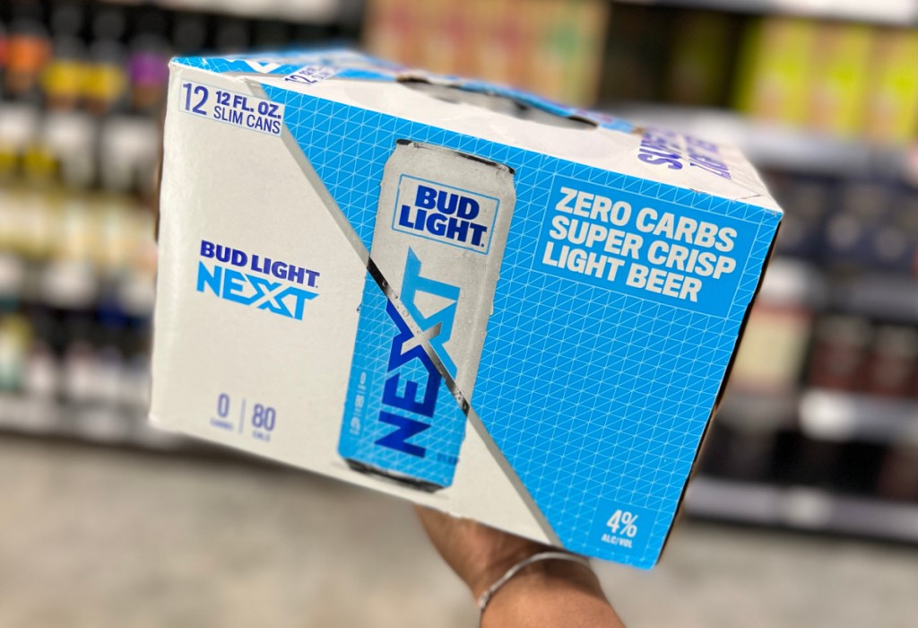 Hand holding a package of Bud Light Next, a low carb beer with zero carbs