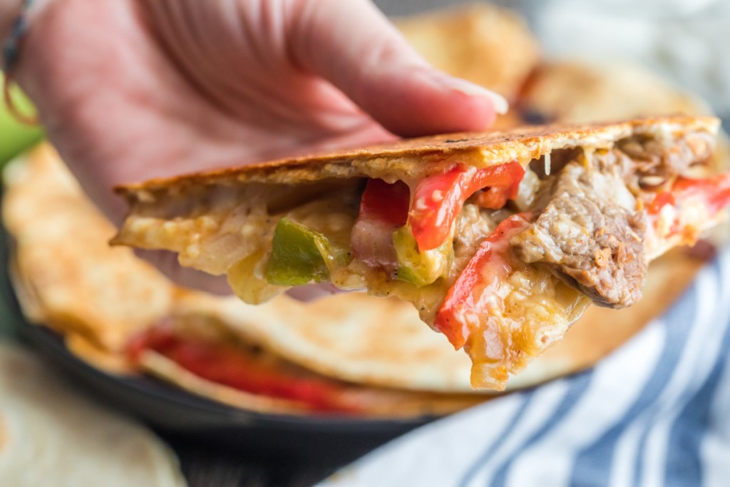 holding a steak quesadilla