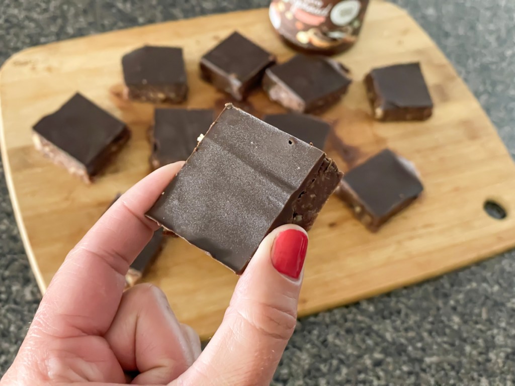 holding a chocolate no bake cookie bar 