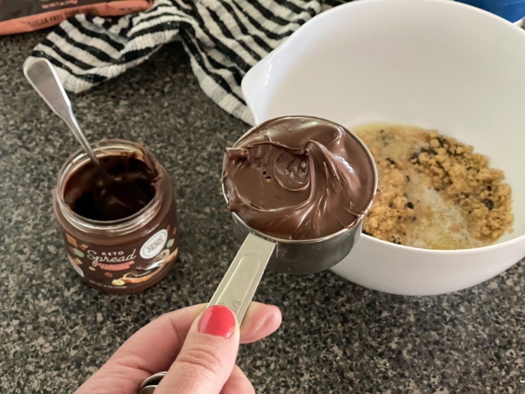 measuring cup of choczero keto dark chocolate hazelnut spread