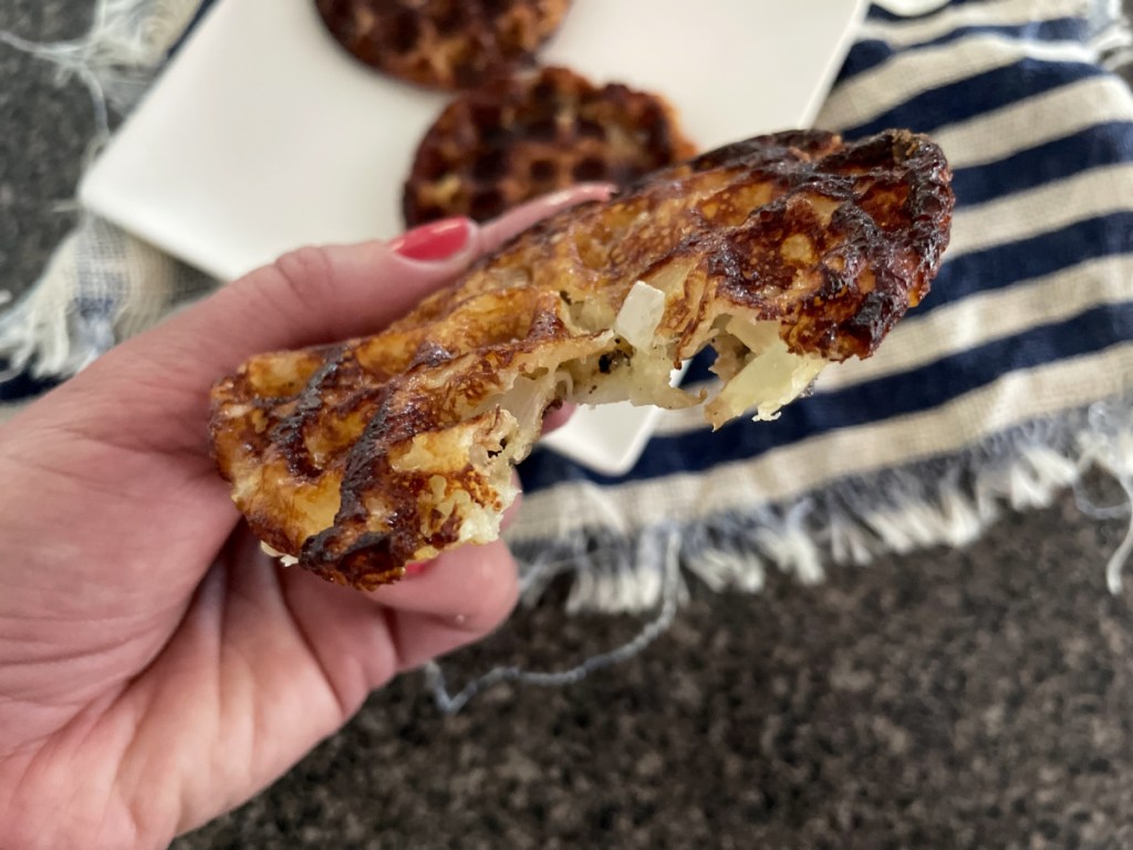 keto onion ring chaffle with a bite out of it