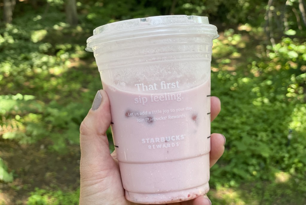 hand holding a homemade keto pink drink low carb copycat of the starbucks beverage