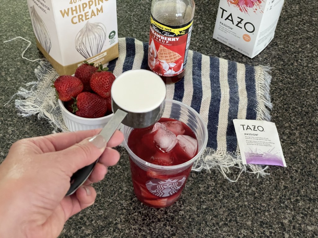 Pouring Whipping Cream into a homemade Keto Pink Drink