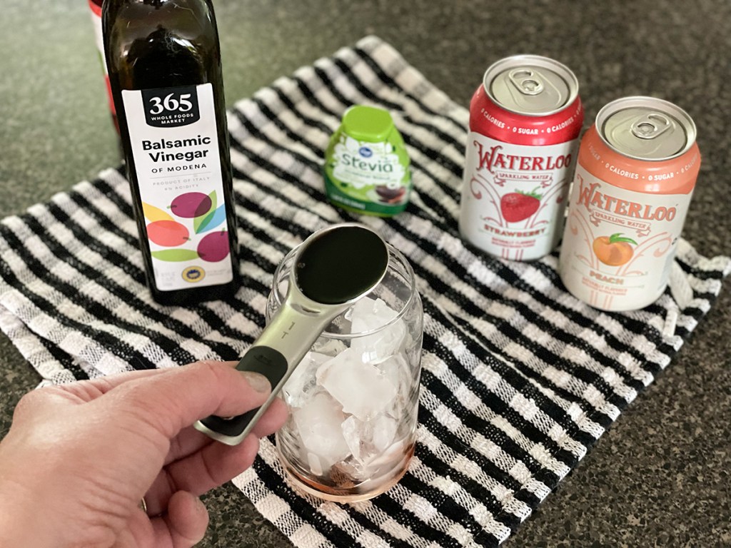 adding balsamic vinegar to a glass