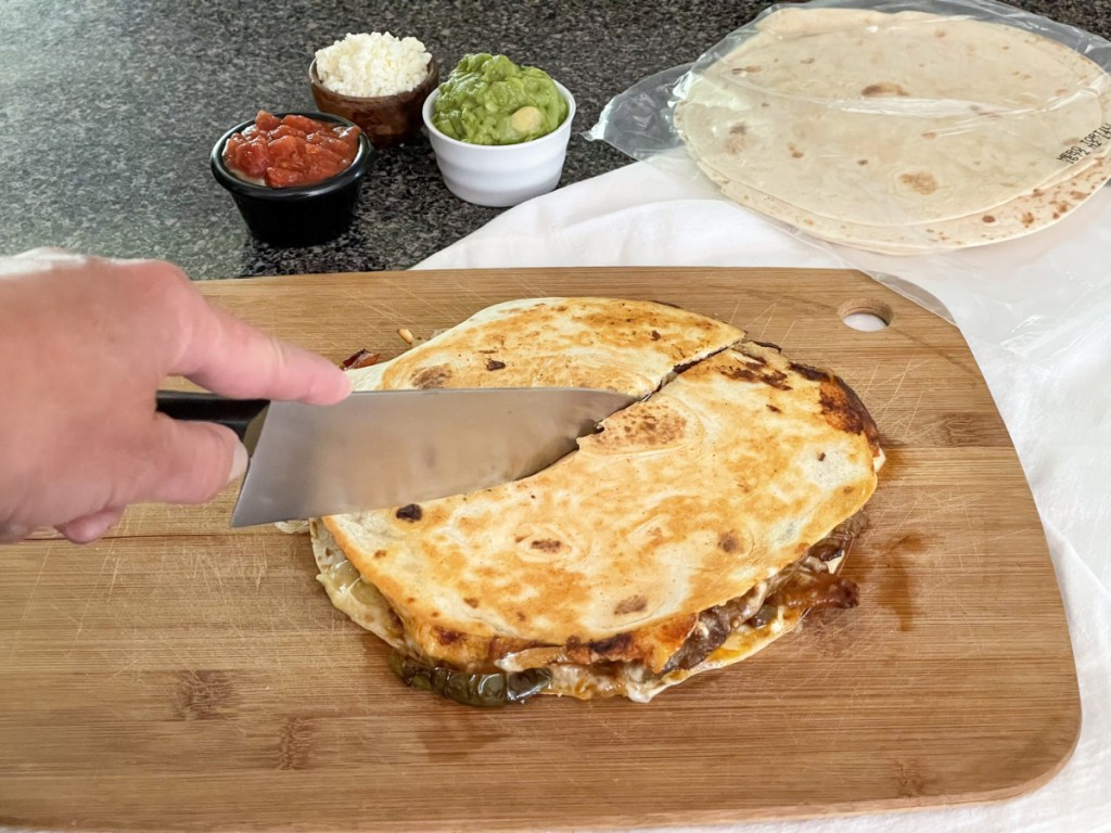 cutting steak quesadilla in half