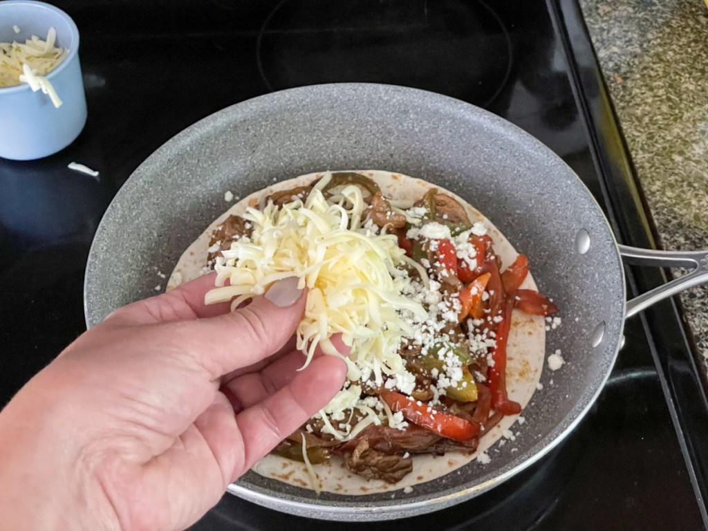 adding Monterey jack cheese to steak quesadilla 