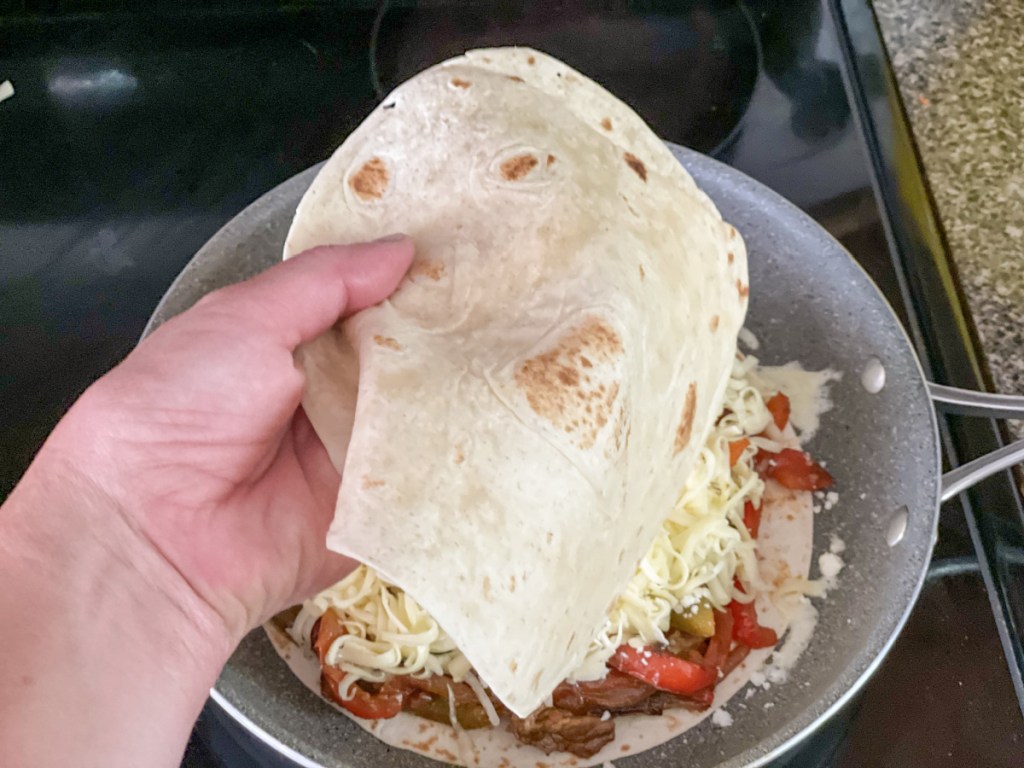 topping steak quesadilla with hero tortilla 