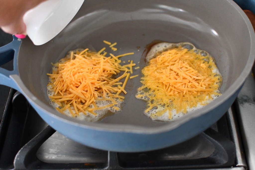 shredded cheese in frying pan