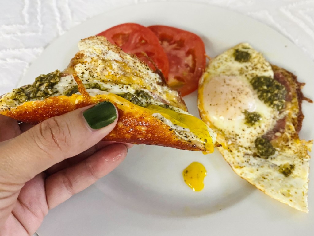 fried eggs with cheese with salami and pesto