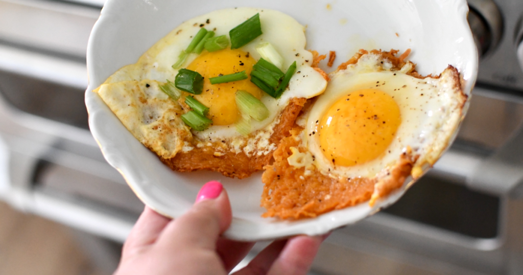 holding plate with fried eggs with cheese