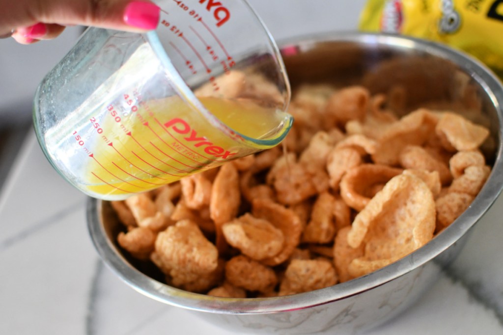 pouring melted butter on pork rinds