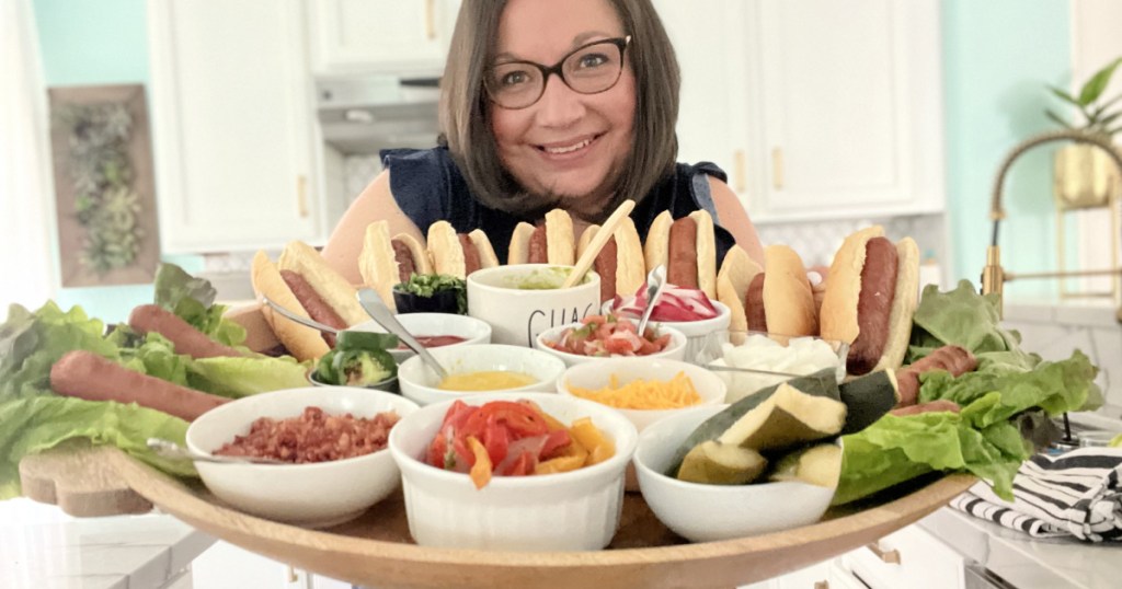 woman holding a keto hot dog board with keto hot dog buns