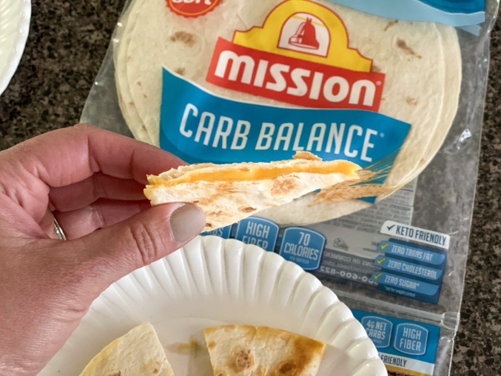 holding a cheese quesadilla