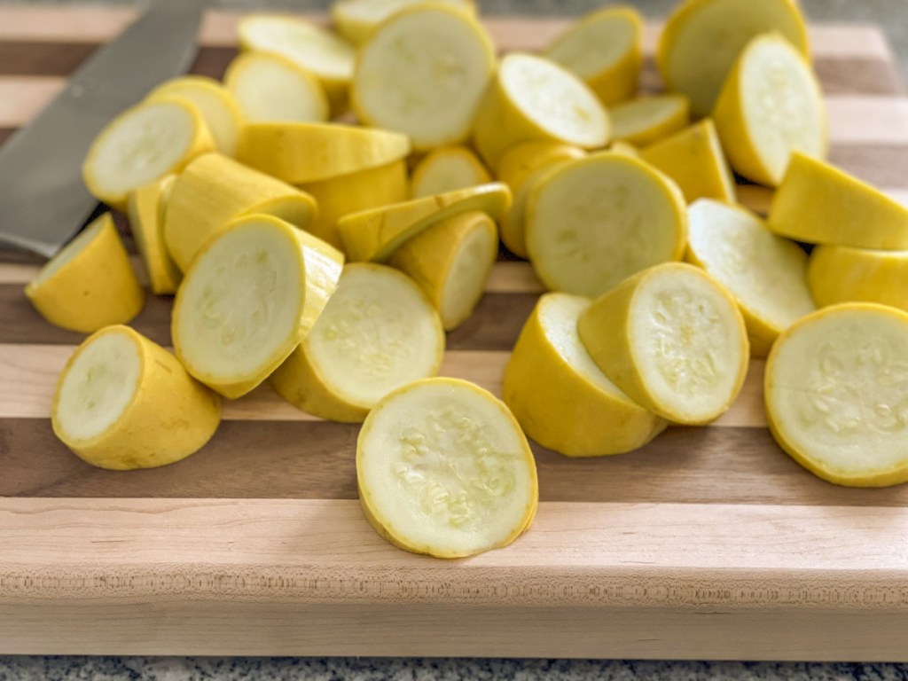 sliced yellow squash on a cutting board