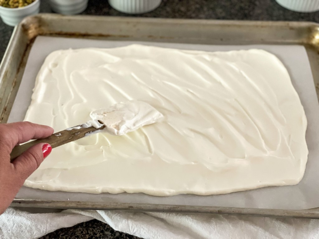 spreading yogurt on baking sheet