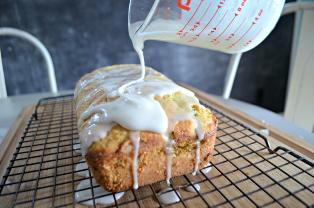 Pouring Lemon Glaze on almond flour keto zucchini bread