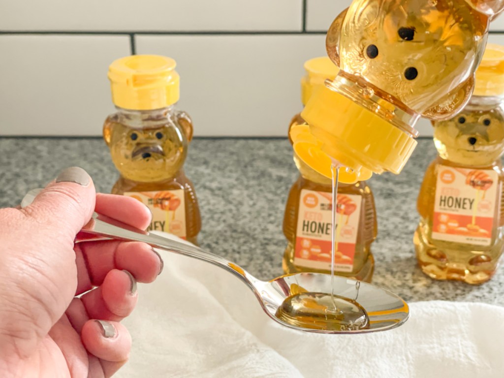 squeezing keto honey onto a spoon