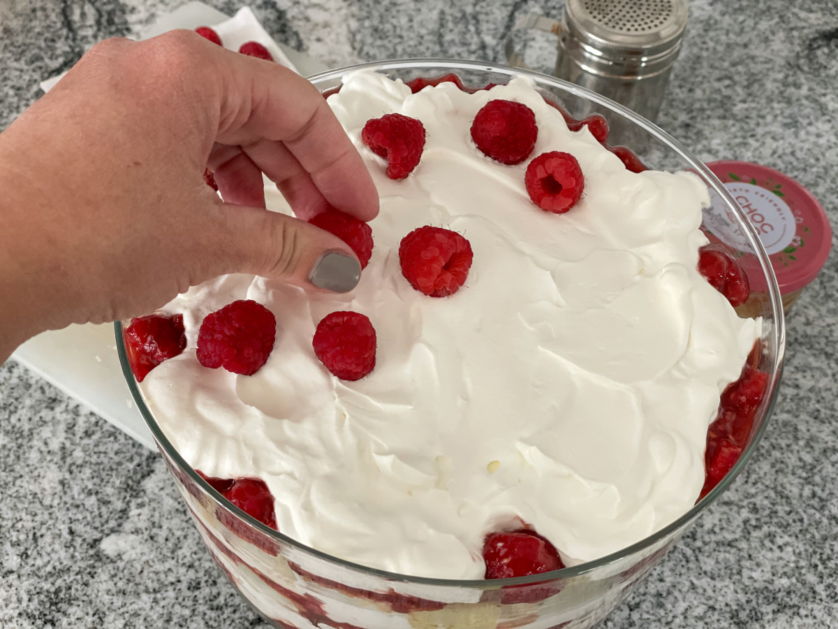 adding fresh raspberries to keto raspberry trifle