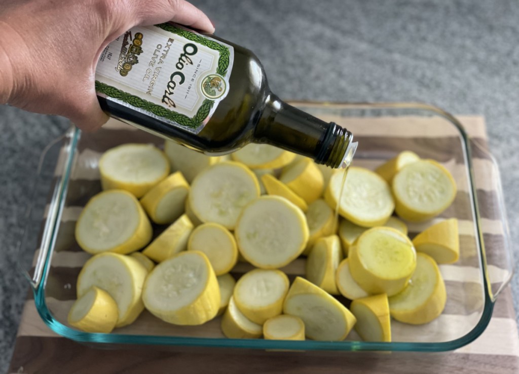Pouring Olive Oil on baked yellow squash