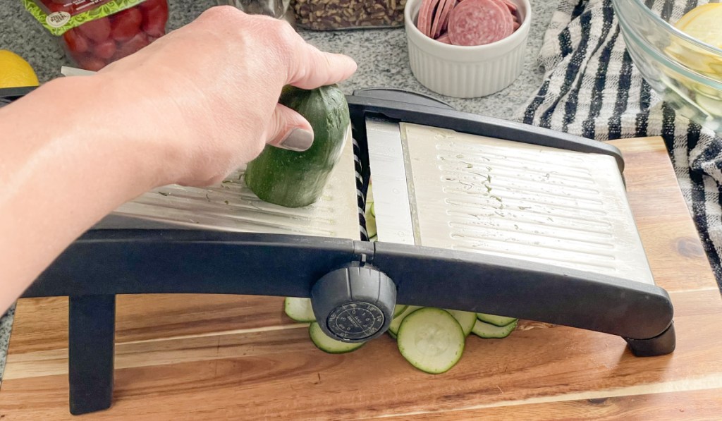 slicing a zucchini with a mandolin 