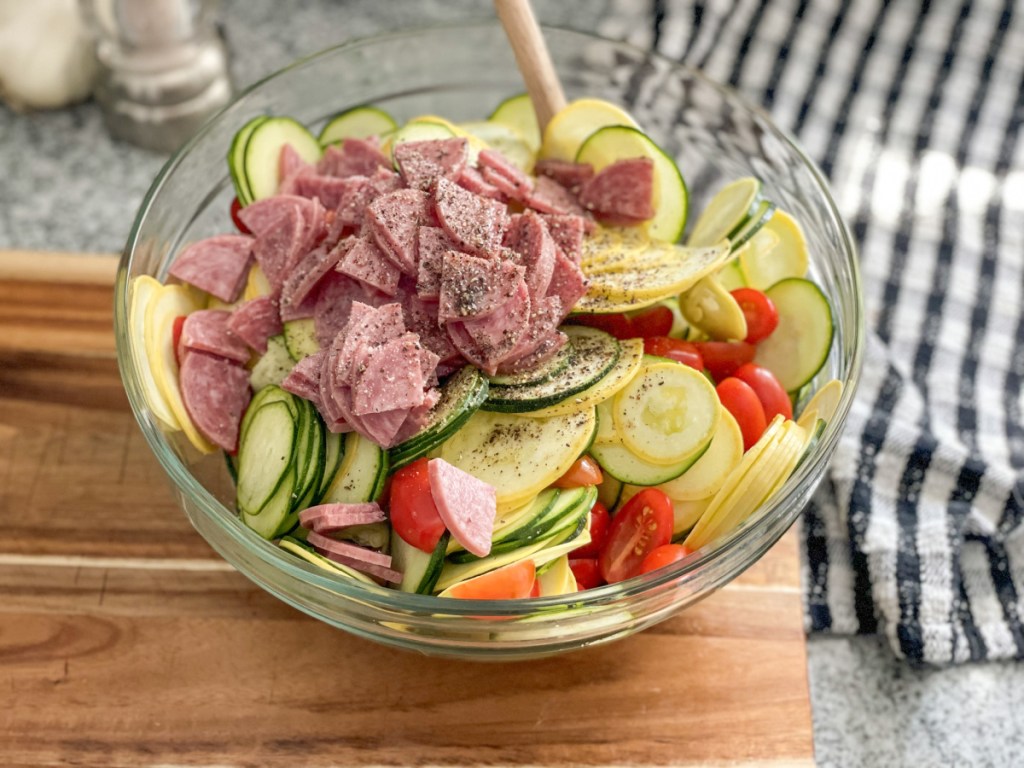 bowl of sliced zucchini, yellow squash, tomatoes, salami