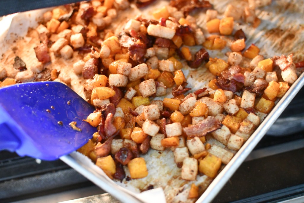 scooping keto butternut squash on a sheet pan