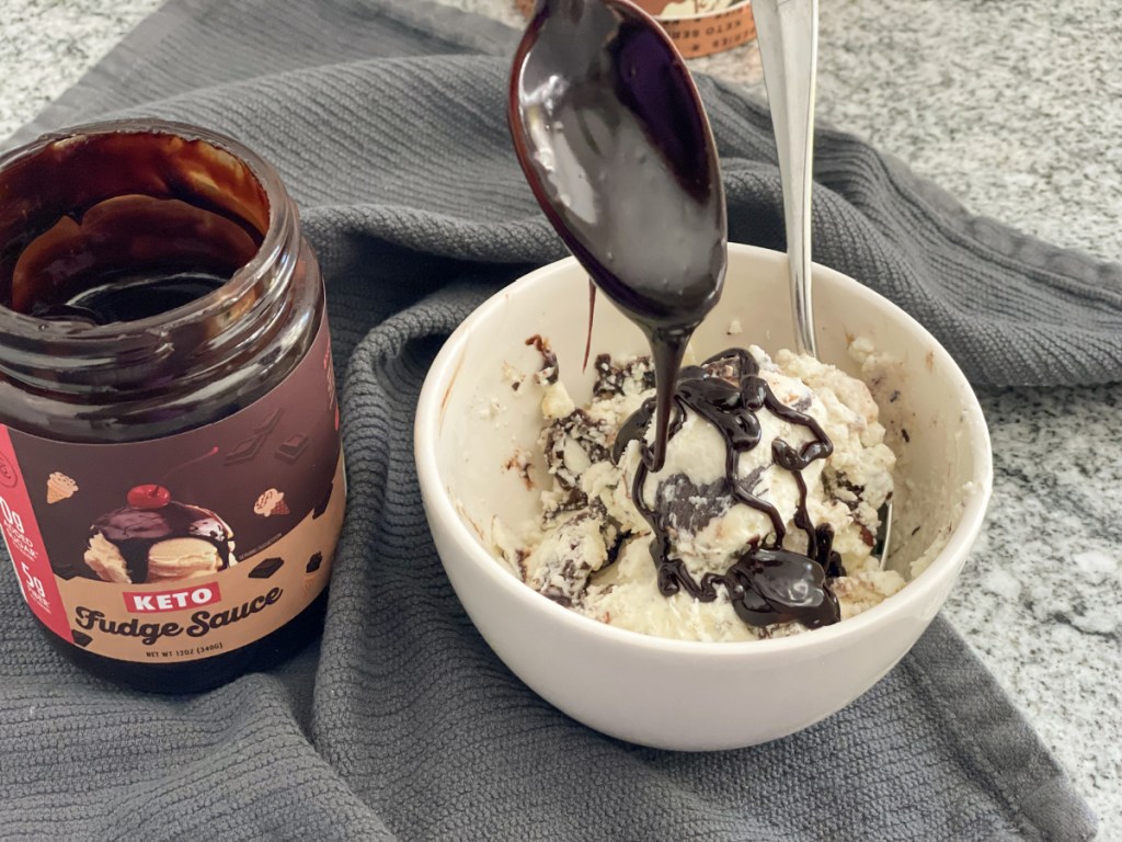 putting choczero keto hot fudge sauce on keto ice cream