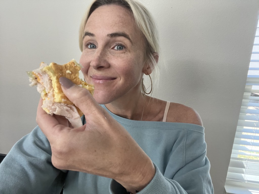 woman holding cloud bread from which wich - keto sandwiches - dining out keto