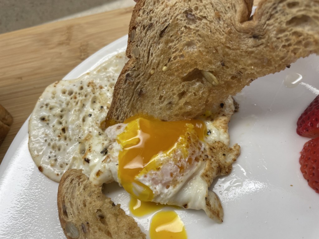 Hero Bread seeded bread dipping in eggs