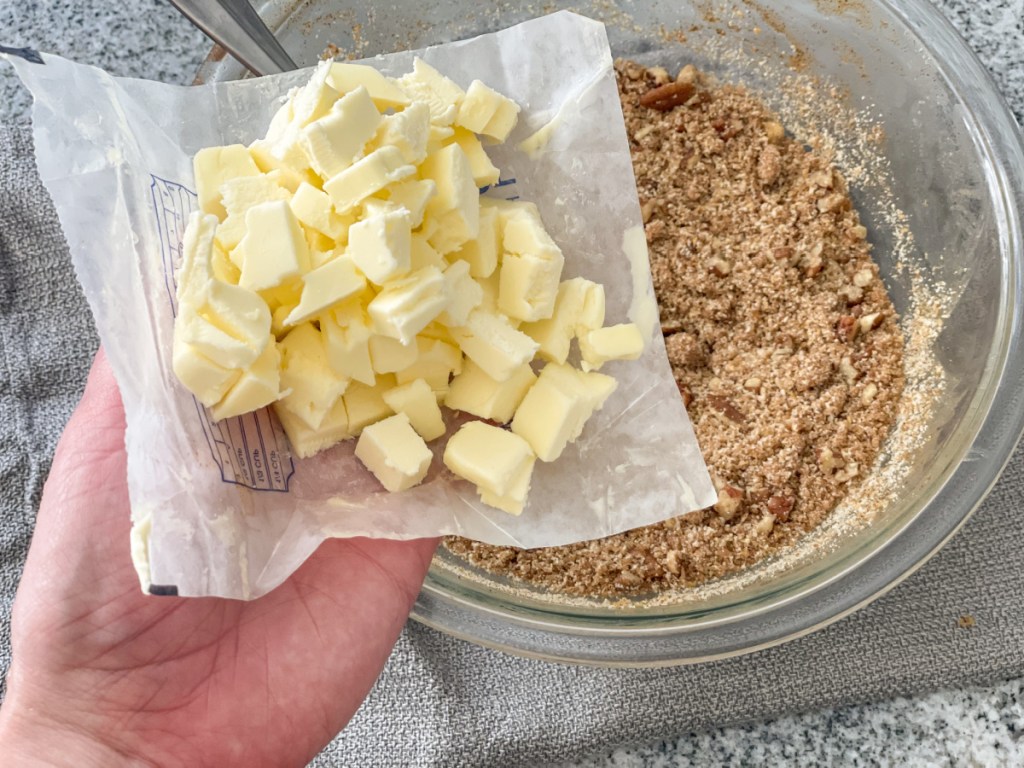 adding butter to crumble topping