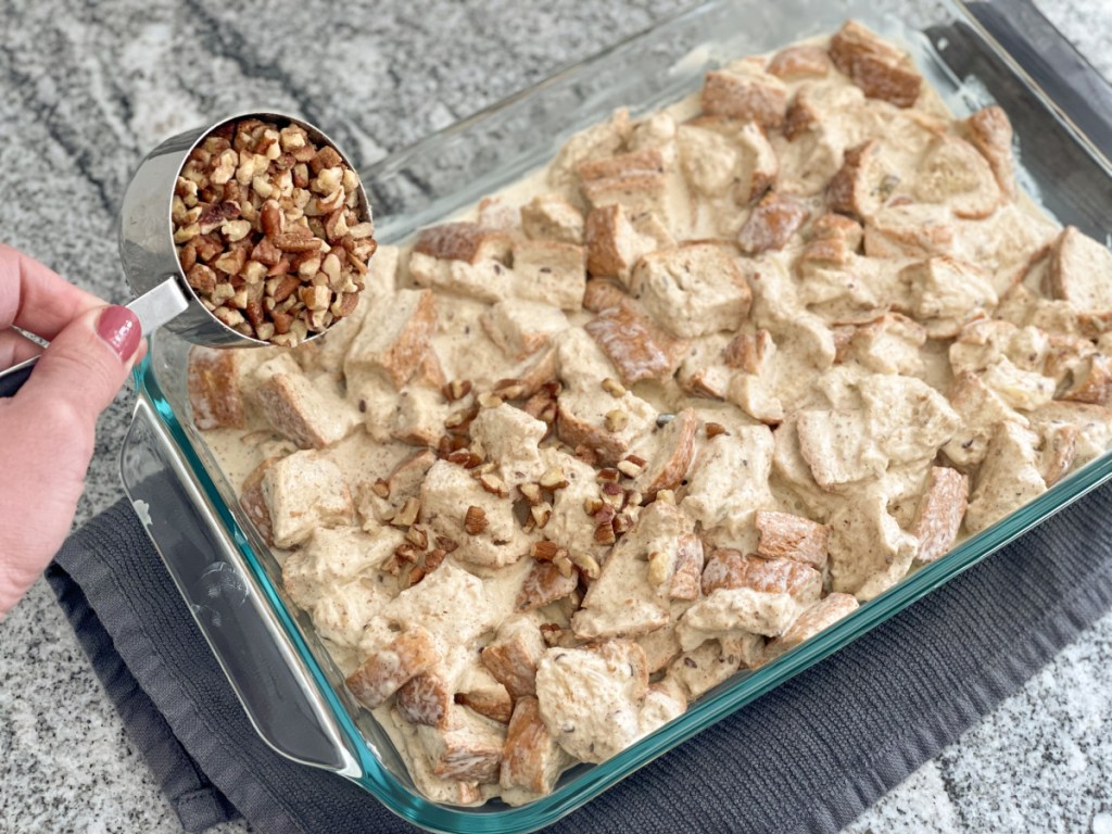 adding pecans to Keto French Toast Casserole