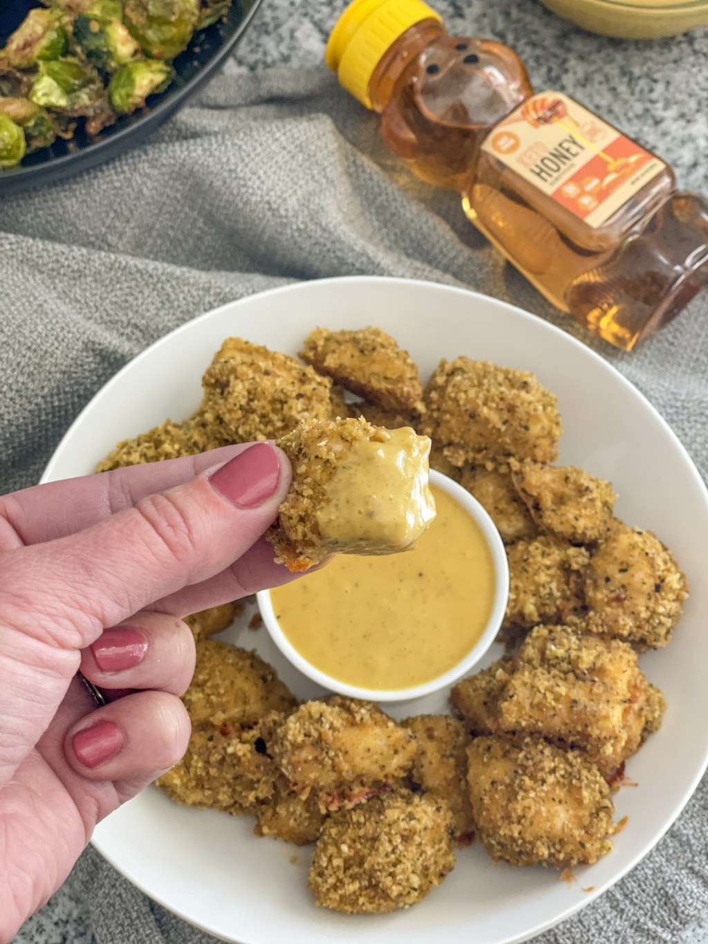 keto chicken nuggets dipping in keto honey mustard 