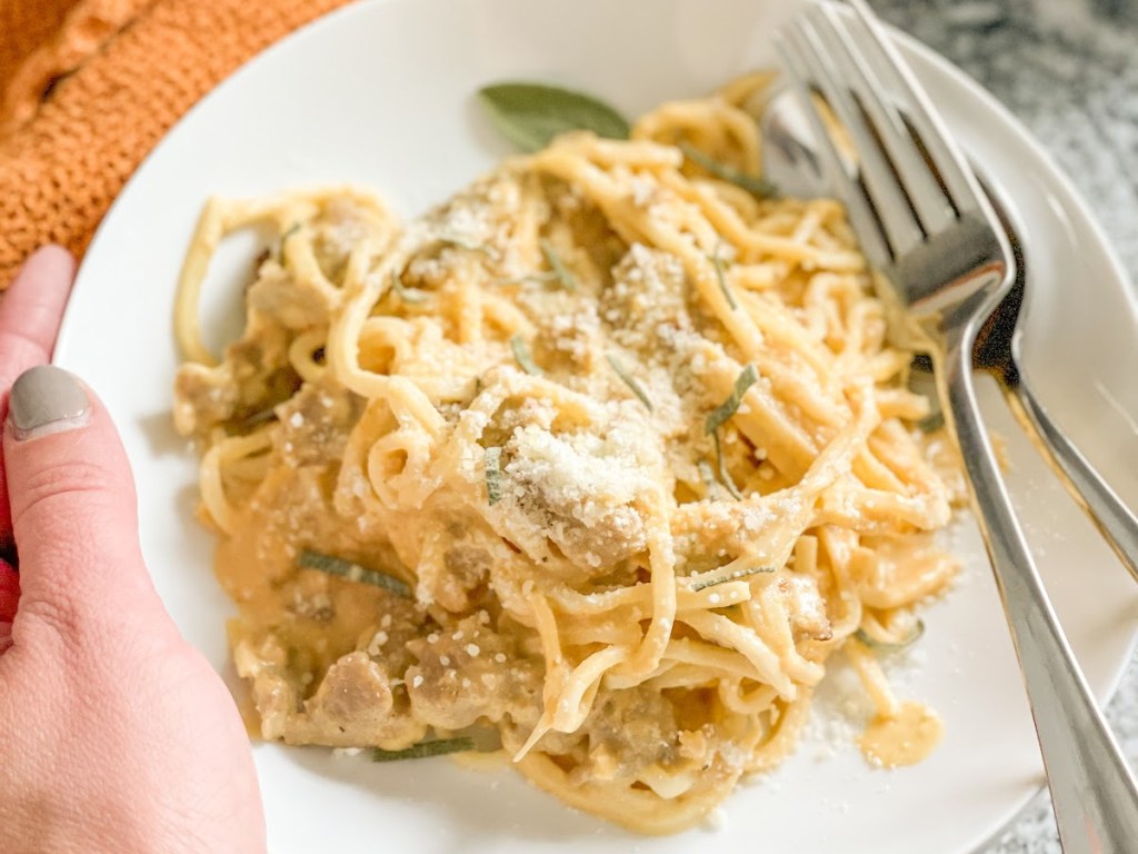 holding plate of keto pumpkin Alfredo