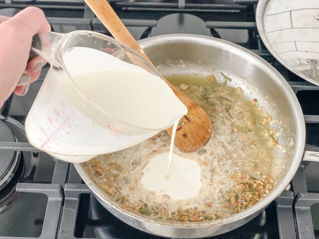 adding heavy whipping cream to skillet