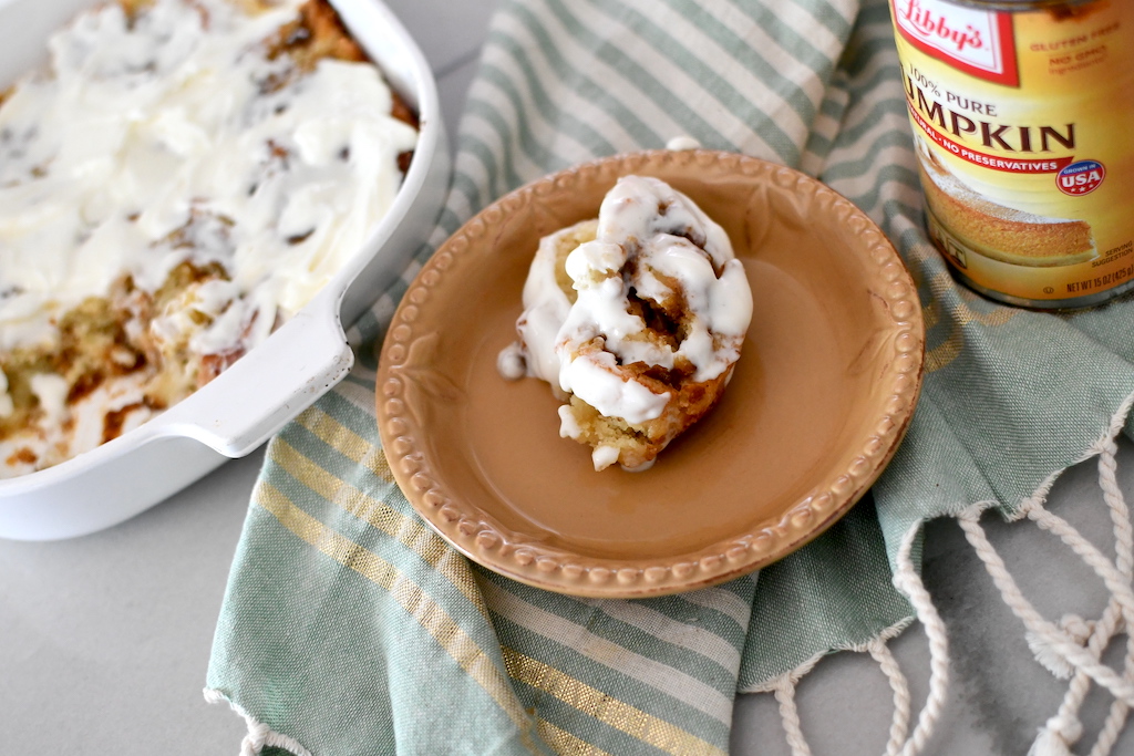 keto pumpkin cinnamon roll on plate with frosting